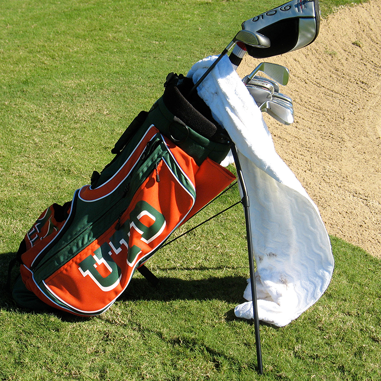 U-T-D golf bag and clubs near sandtrap