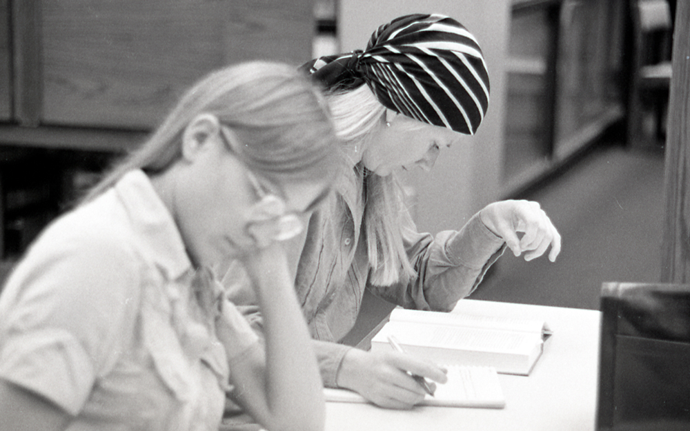 Two women studying in the library