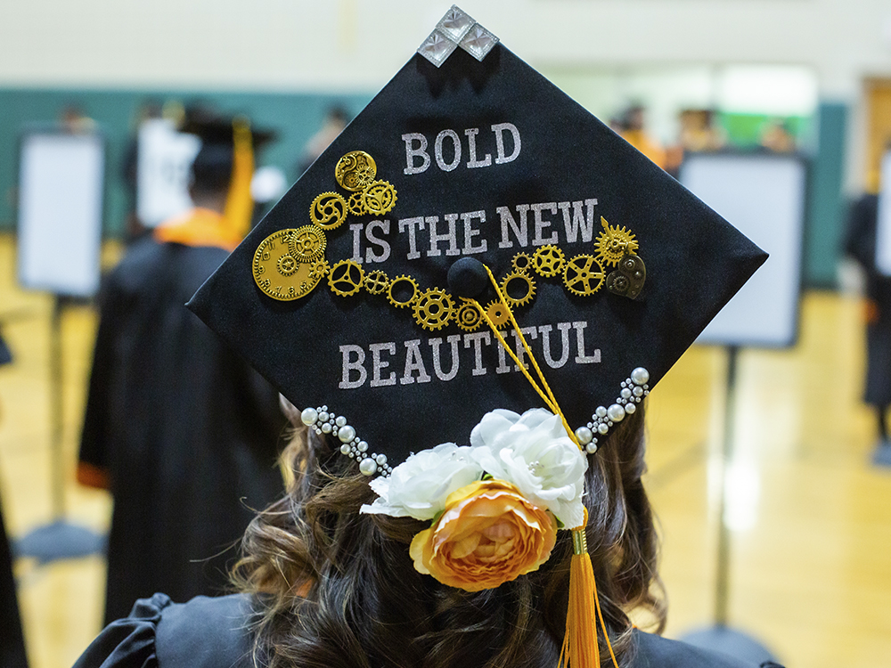 Woman wearing cap that says bold is the new beautiful