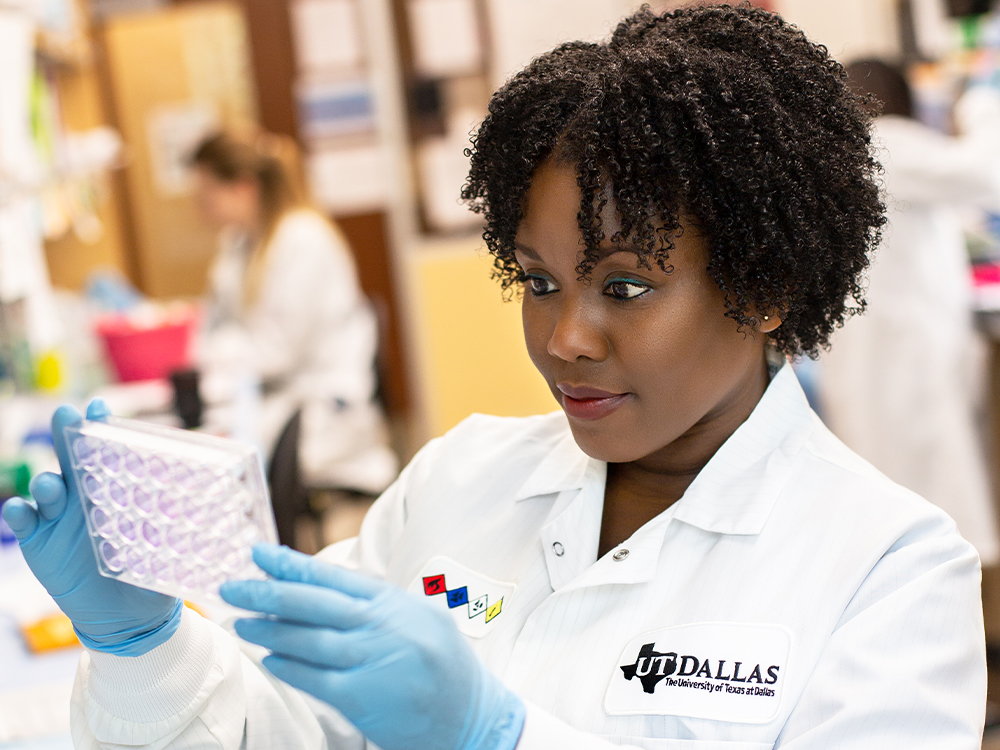 Scientist examines lab sample