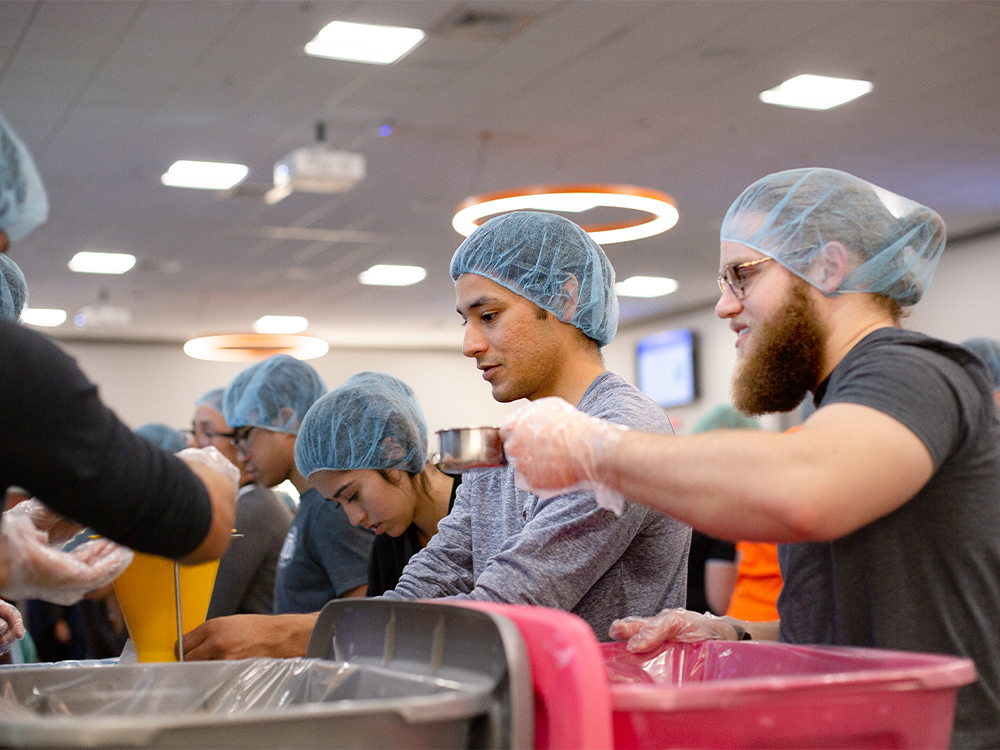 Students pack food during a volunteer event.